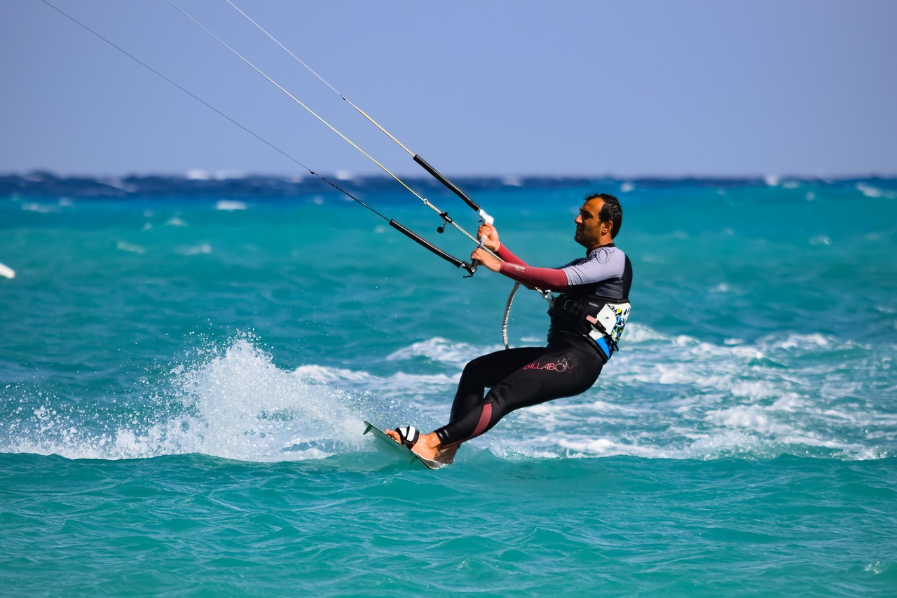 Kiteboarder carving a turn in strong spring wind