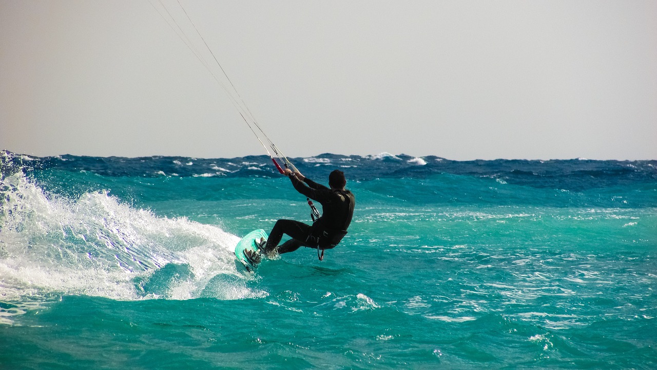Kiteboarder riding upwind across open water